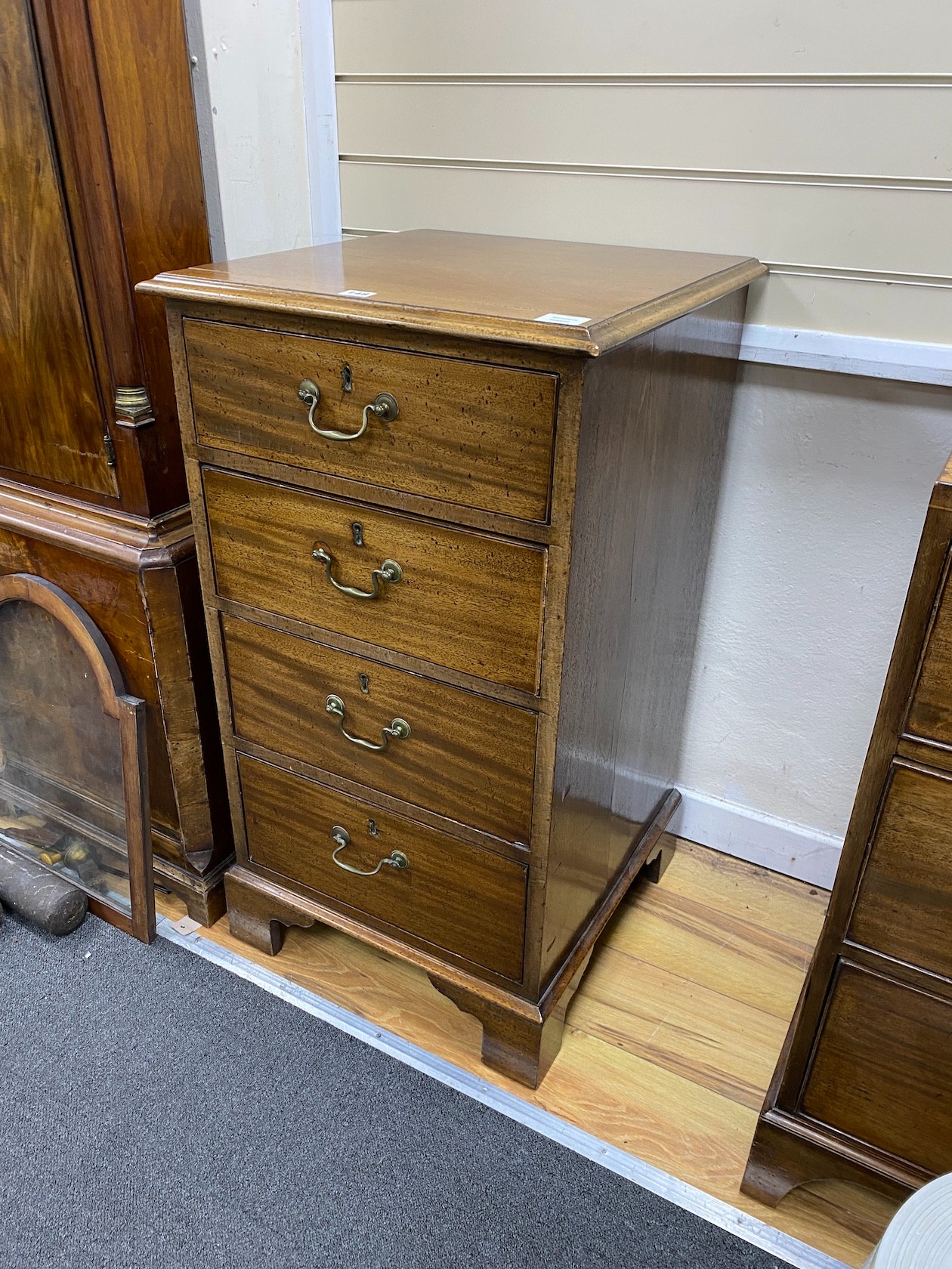A mahogany chest of four short drawers, width 53cm, depth 53cm, height 96cm